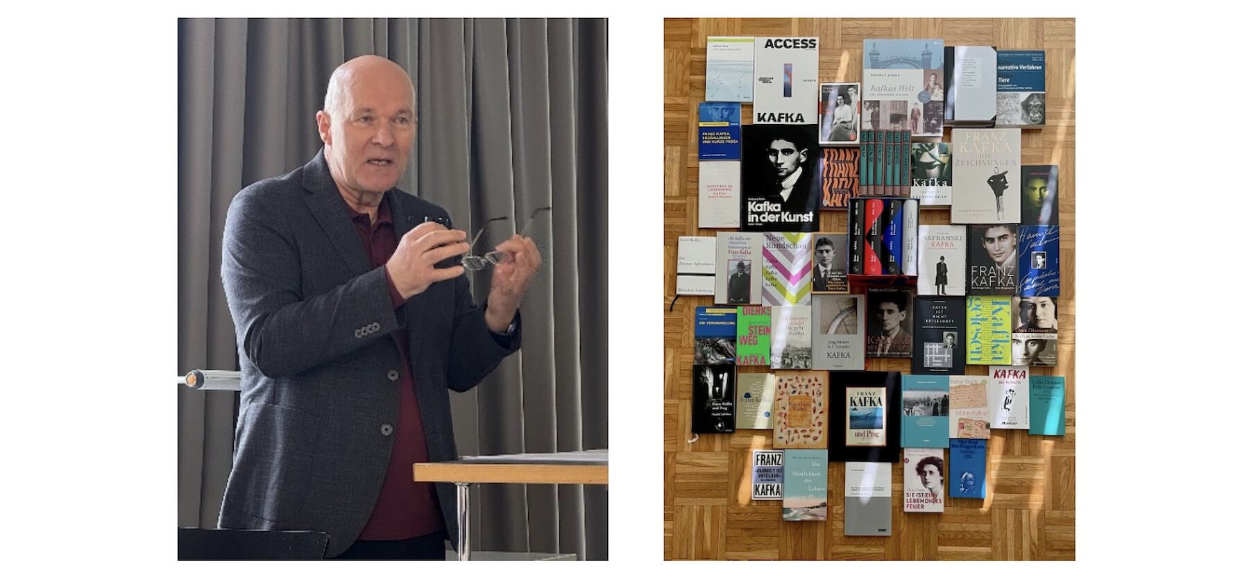 Ein Mann spricht auf einem Podium neben einer Ausstellung verschiedener Bücher, die auf dem Boden ausgebreitet sind.